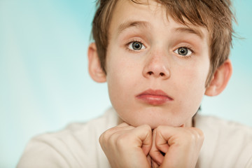 Dubious young boy with a sceptical expression