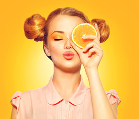 Beauty model girl takes juicy oranges