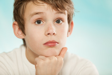 Thoughtful young boy watching intently