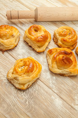 wheat buns, rolls with cinnamon, rolling-pin, meal on the table