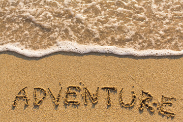 Adventure - drawn of the hand on the beach sand, soft surf wave.