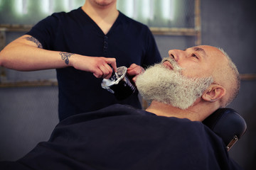 Obraz na płótnie Canvas Barber shaving with brush shaving foam
