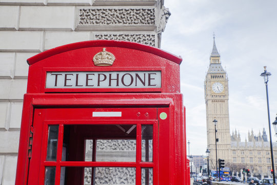 red telephone booth in London England on against big Ben