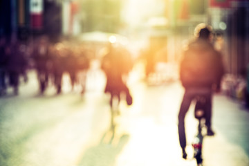 People and cyclist in the street, urban, abstract blurry