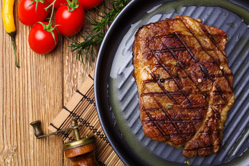 Grilled beef steak with spices ina pan.