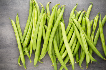 Green beans  on a gray background.