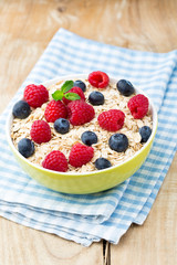 Oatmeal porridge with berries. Raspberries and blueberries.