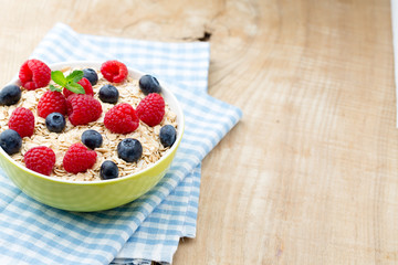 Oatmeal porridge with berries. Raspberries and blueberries.