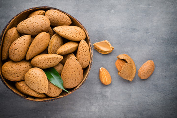 Group of almond nuts with leaves.Wooden background.