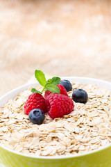 Oatmeal porridge with berries. Raspberries and blueberries.
