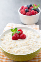 Oatmeal porridge in bowl with berries raspberries and blackberri
