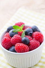 Oatmeal porridge in bowl with berries raspberries and blackberri