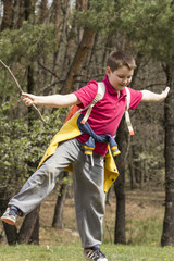 Young boy balances on a rock