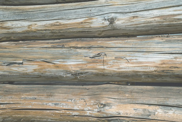 a wall made of old logs pale grey 