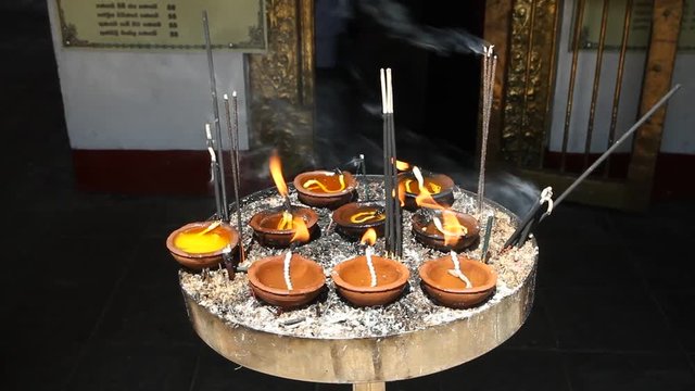 Coconut oil lamps and burning incense  in Kandy temple, Sri Lanka