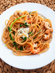 Italian spaghetti pasta with shrimps and cream. Shot from above, vertical shot