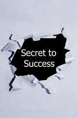 secret to success written under torn paper