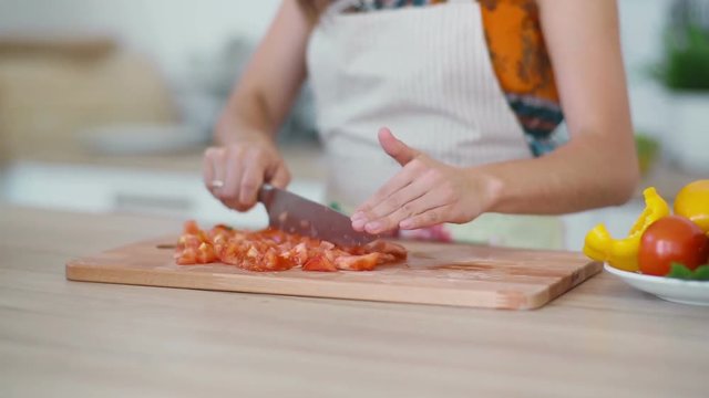Woman grinds tomato