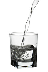 Water pouring into glass isolated on white