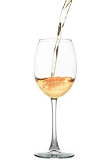 White wine flowing into a glass isolated on white