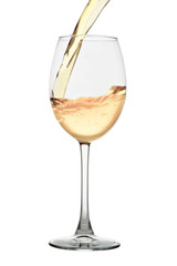 White wine pouring into a glass isolated on white