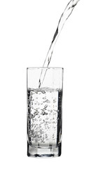 Water pouring into glass, air bubbles in the water, isolated on