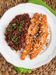 Baked salmon with brown wild rise side dish. Vertical shot, high angle view