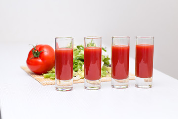 Four glass cups tomato juice