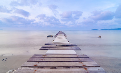 Wooded bridge in the port between sunrise.