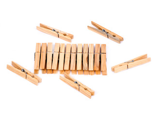 Natural wood clothespins separated on white background