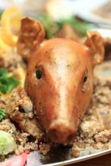 Head of roasted pig with porridge