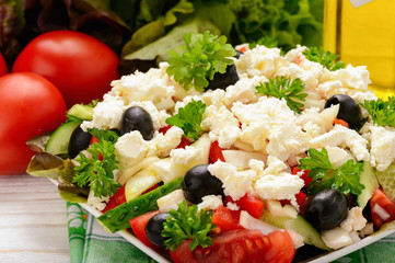 Vegetable salad with tomatoes, cucumbers, oilves and feta cheese -bulgarian traditional summer salad.