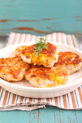 cutlets from poultry with grains of corn