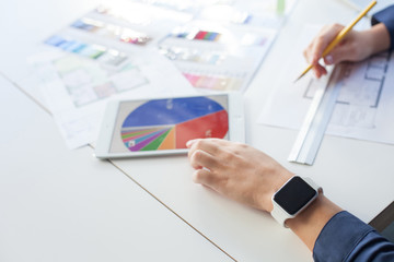 Skillful interior designer is working in office