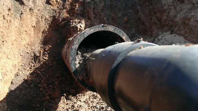 A trench with a gas  pipeline, polypropylene pipe deeper in the ground

