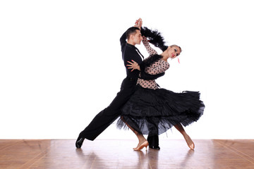 Latino dancers in ballroom against white background