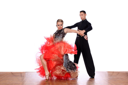Latino dancers in ballroom against white background