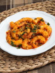 Pan fried shrimps with tomatoes, garlic and basil sauce. Vertical shot.