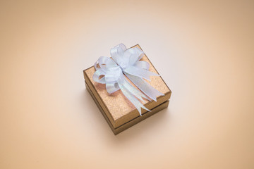 Luxury golden gift box on brown background