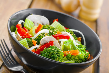Steamed broccoli with vegetables. Vegetable salad in bowl. International healthy vegetarian food. Close-up.