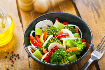 Bowl of delicious salad made of vegetables.  Healthy vegetarian food. Top view..