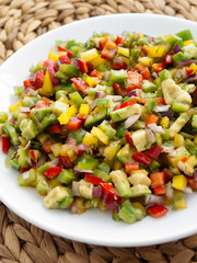 Healthy salsa salad with red and green peppers, onions and avocado