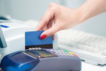 POS Terminal Transaction. Hand Swiping a Credit Card.