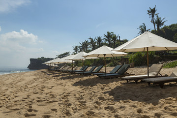 Balangan beach with parasol, Nusa Dua, is one of the most beautiful in Bali, it is called Mars at its bottom is covered with volcanic rock.