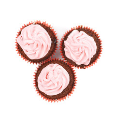 Chocolate muffin with pink cream isolated