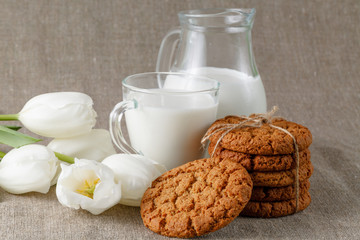 Homemade cookies and glass of milk on table