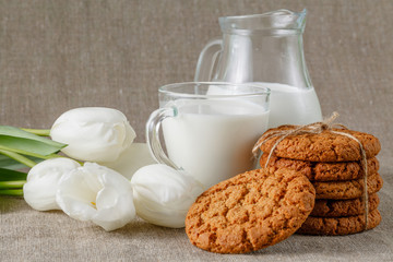 Homemade cookies and glass of milk on table