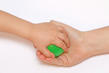 hand the child tries to take away green balls mom