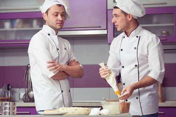 Tiramisu cooking concept. Portrait of two funny working men