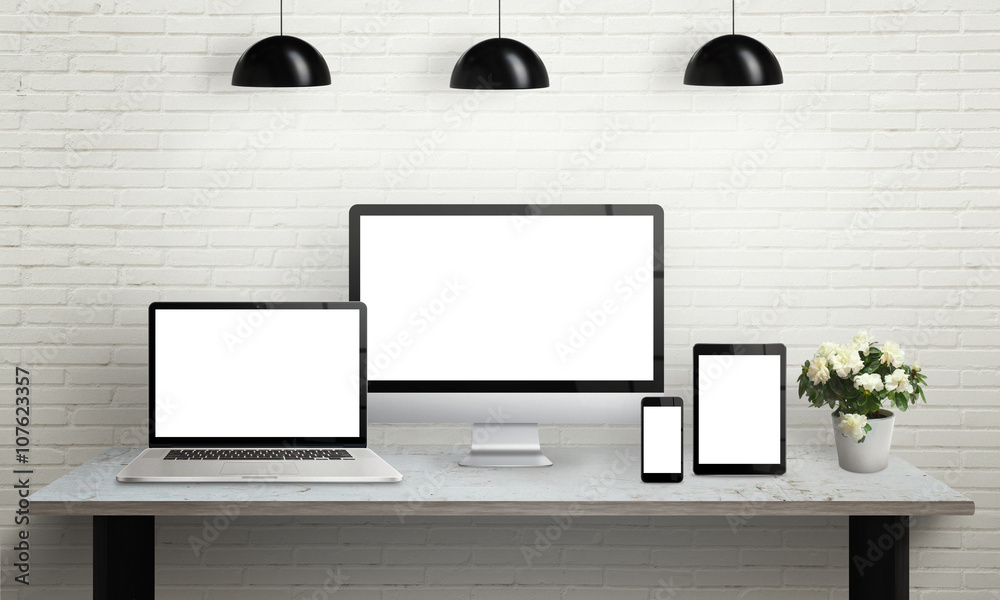 Aufkleber devices on desk with isolated screen for mockup. computer display, laptop, tablet and smart phone on